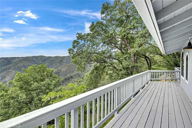 a view of balcony with wooden floor and fence