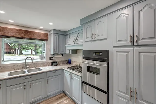 a kitchen with stainless steel appliances granite countertop a sink and cabinets