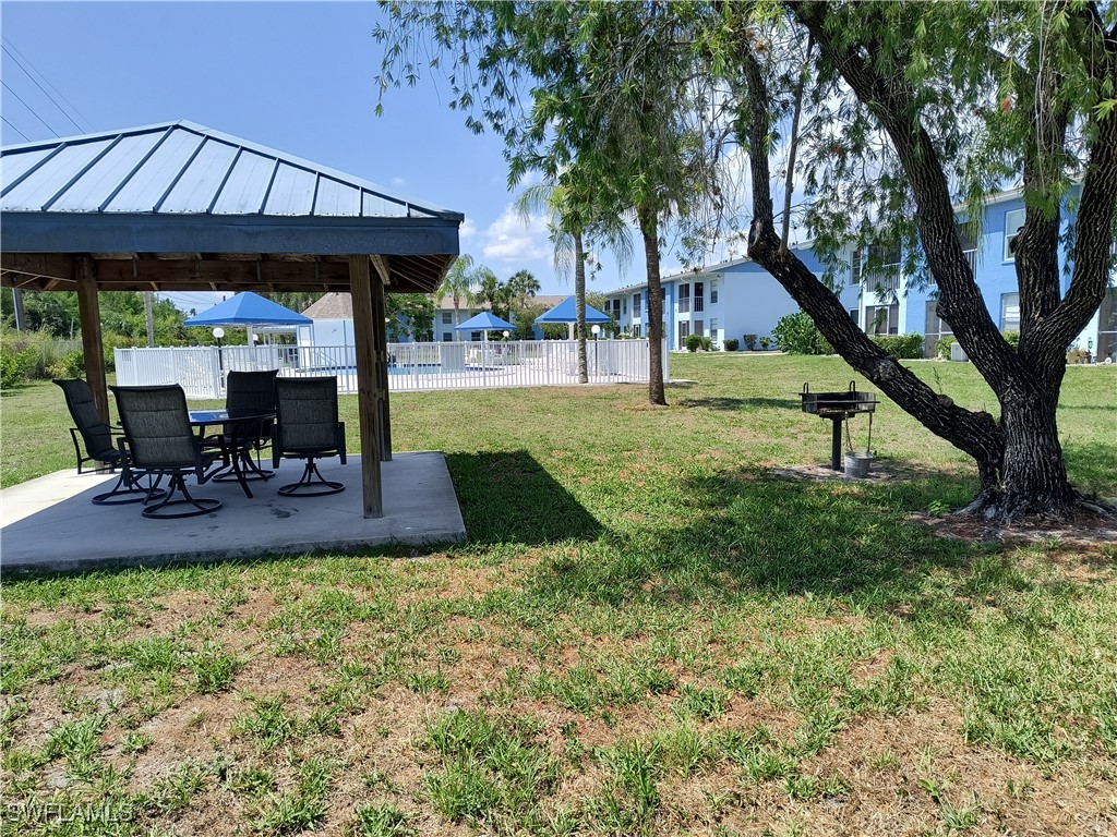 1100 Pondella Road, Unit 1001 Cape Coral, FL 33909 - Photo 12 of 14 a view of a house with backyard and sitting area