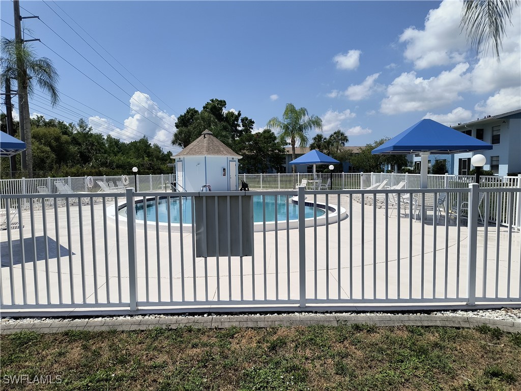1100 Pondella Road, Unit 1001 Cape Coral, FL 33909 - Photo 13 of 14 a view of a house with wooden fence
