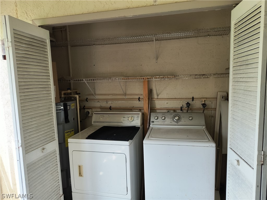 1100 Pondella Road, Unit 1001 Cape Coral, FL 33909 - Photo 4 of 14 a utility room with dryer and washer