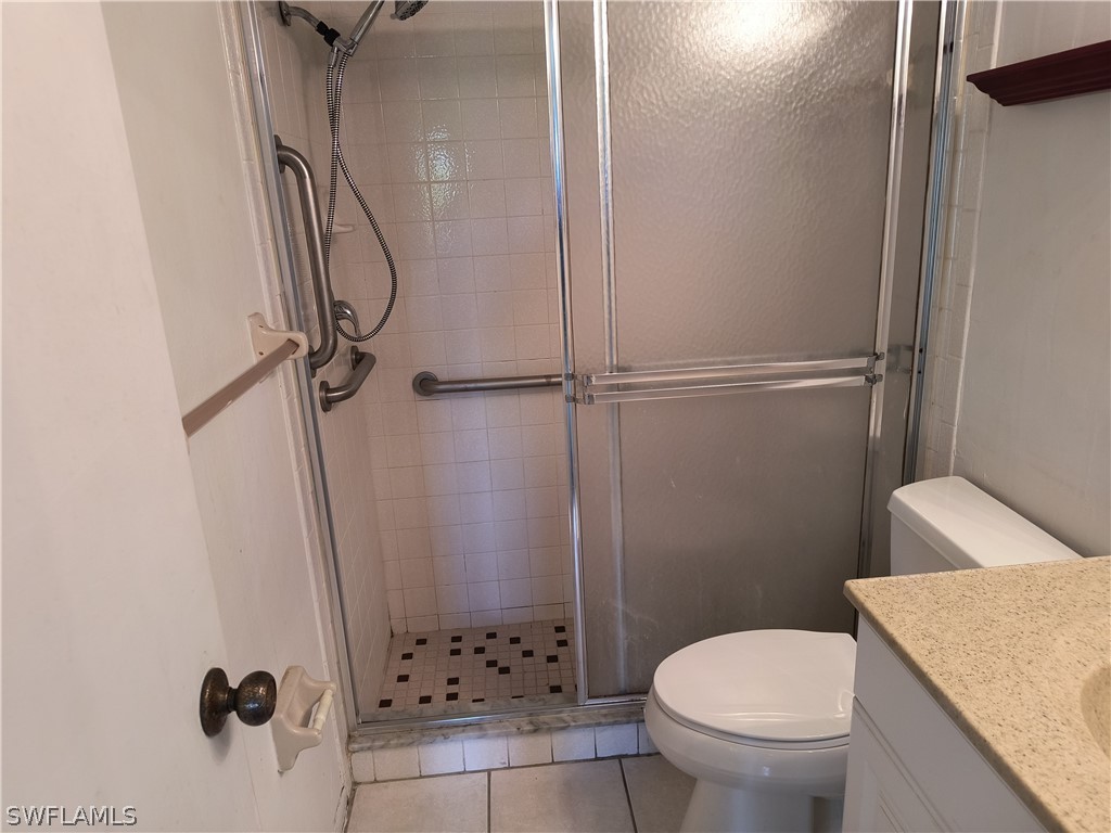 1100 Pondella Road, Unit 1001 Cape Coral, FL 33909 - Photo 6 of 14 a bathroom with a granite countertop sink toilet and shower