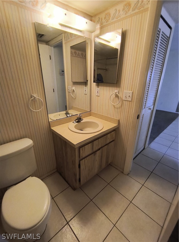 1100 Pondella Road, Unit 1001 Cape Coral, FL 33909 - Photo 8 of 14 a bathroom with a sink a toilet and mirror