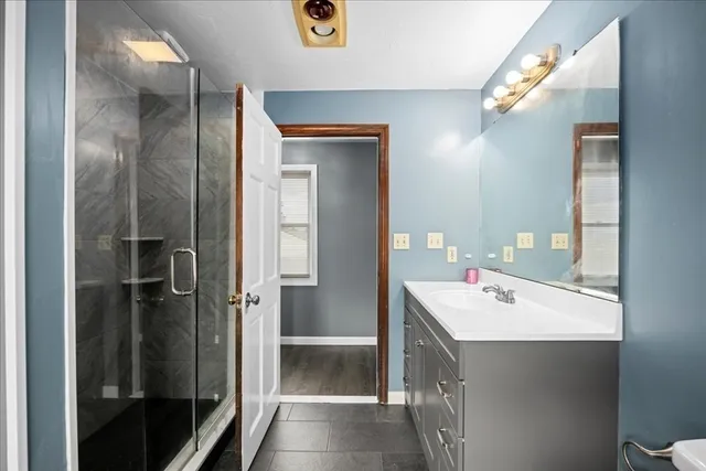 a bathroom with a sink a mirror and a shower