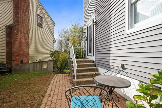 a view of a chair and table in backyard