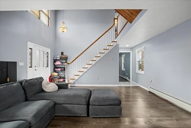 a living room with furniture and wooden floor