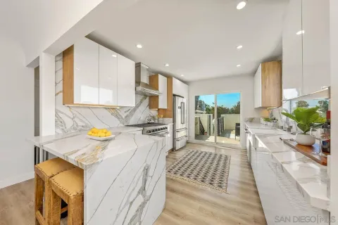 a view of a kitchen with dining table and appliances