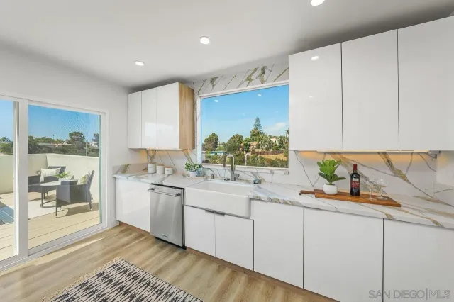 a kitchen with a sink stove and cabinets