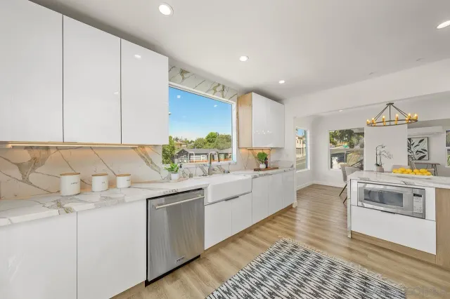 a kitchen with stainless steel appliances granite countertop a sink and cabinets