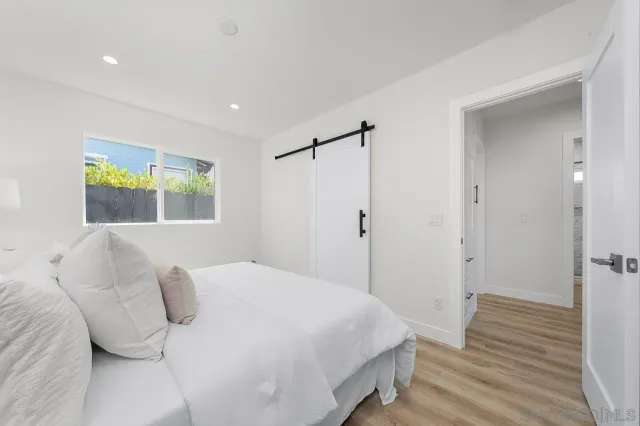 a bedroom with a bed and a window