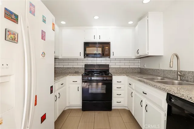 a kitchen with granite countertop a stove top oven and sink