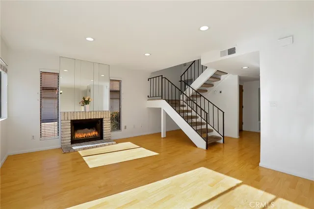 a view of a livingroom with a fireplace stairs and a couch