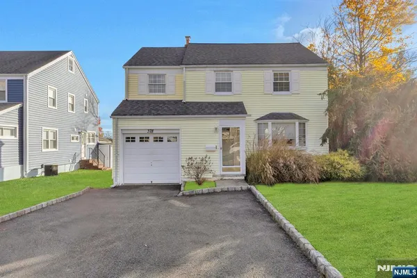 a front view of house with yard and green space