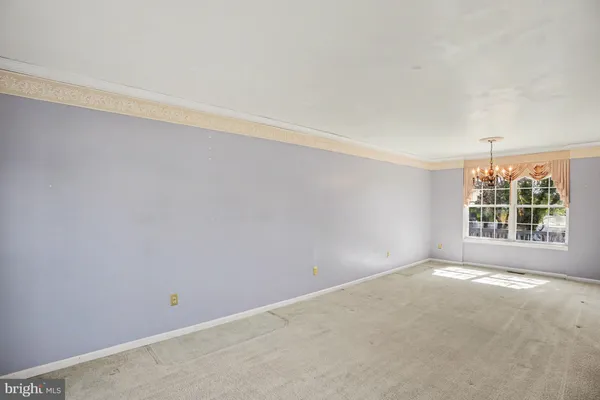 a spacious bedroom with a bed and a large window