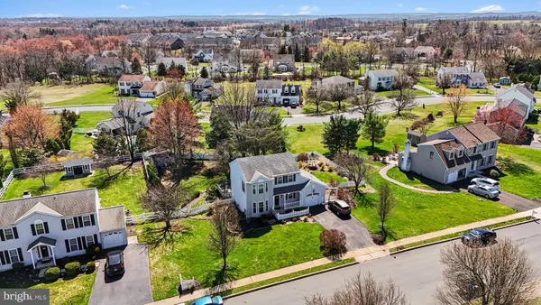 an aerial view of residential houses with outdoor space and river