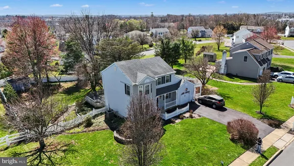 a aerial view of a house with a big yard and large trees