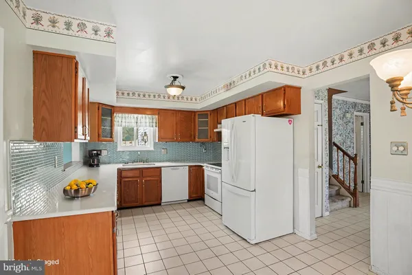 a kitchen with stainless steel appliances granite countertop a sink and a refrigerator