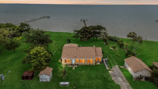 an aerial view of a house with garden space and street view
