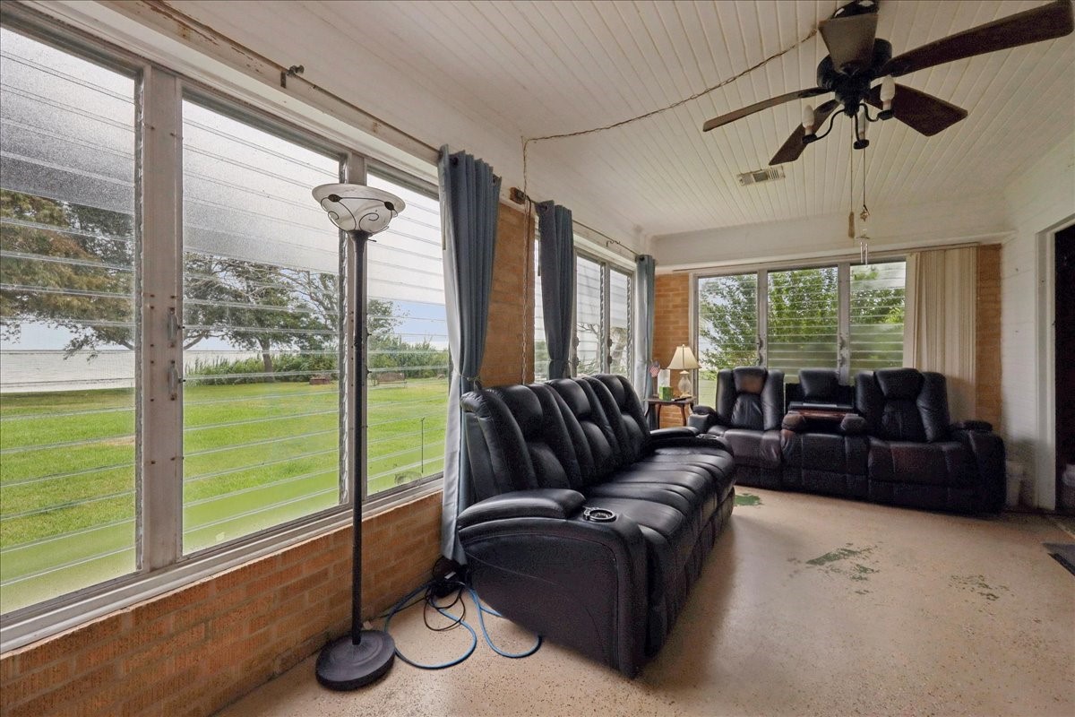 11910 Cedar Gully Road Beach City, TX 77523 - Photo 20 of 50 a living room with furniture and a floor to ceiling window