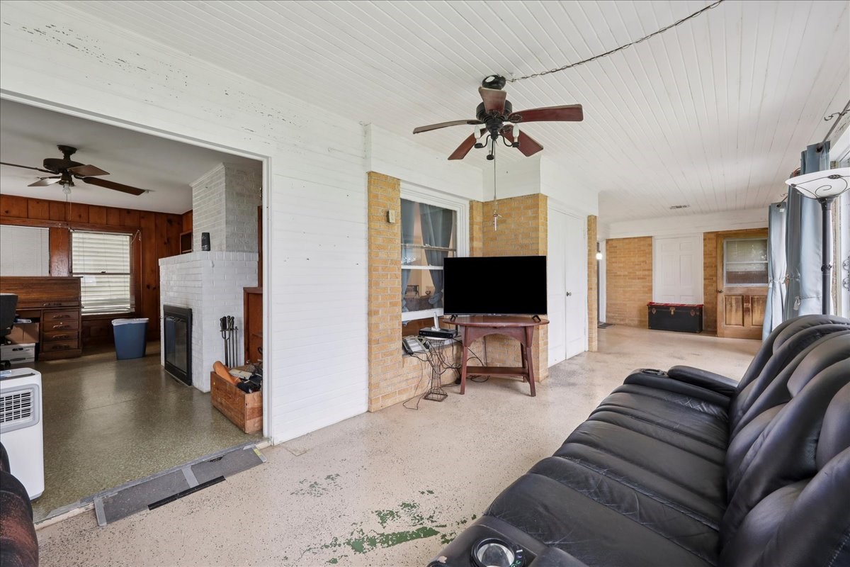 11910 Cedar Gully Road Beach City, TX 77523 - Photo 22 of 50 a living room with furniture and a flat screen tv