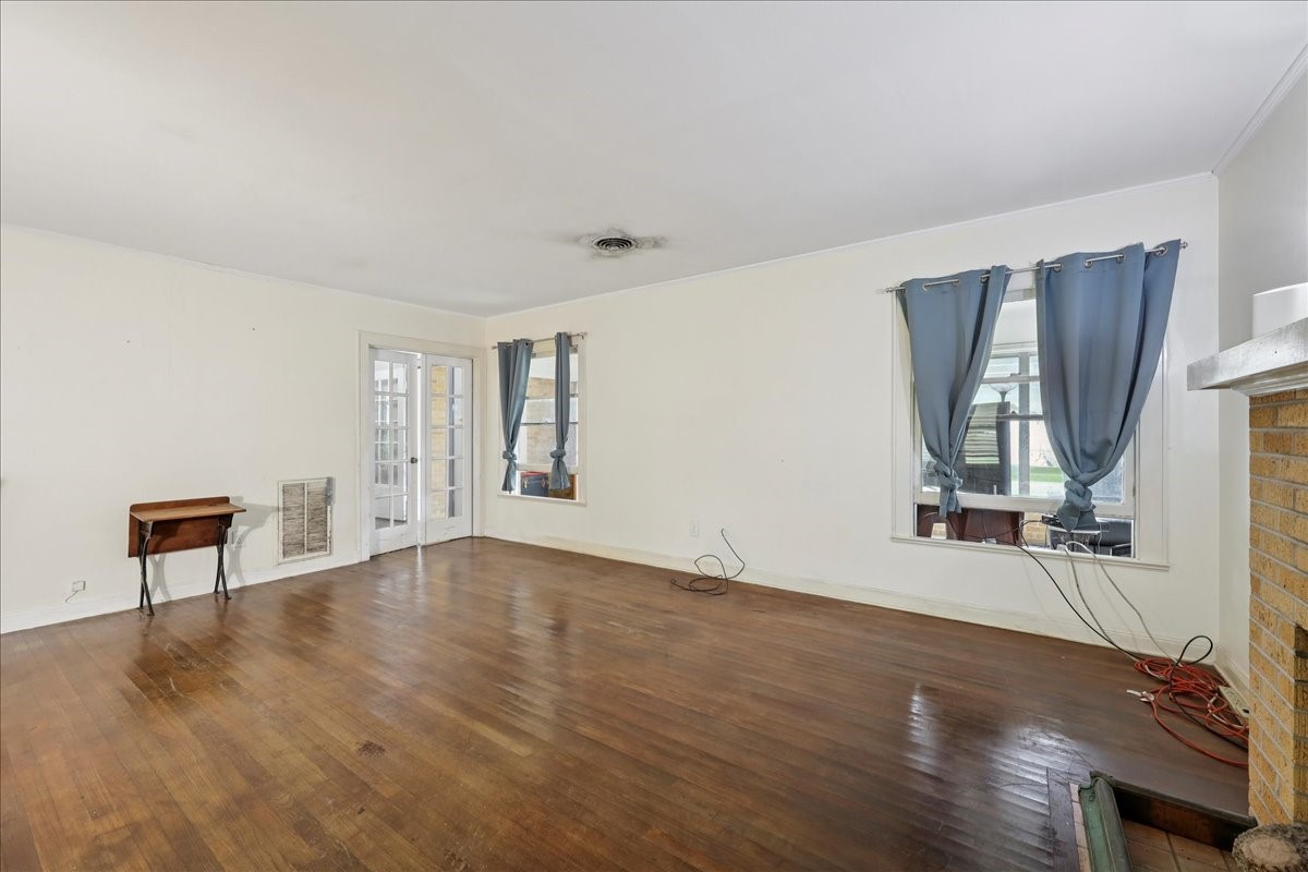 11910 Cedar Gully Road Beach City, TX 77523 - Photo 26 of 50 an empty room with wooden floor and windows