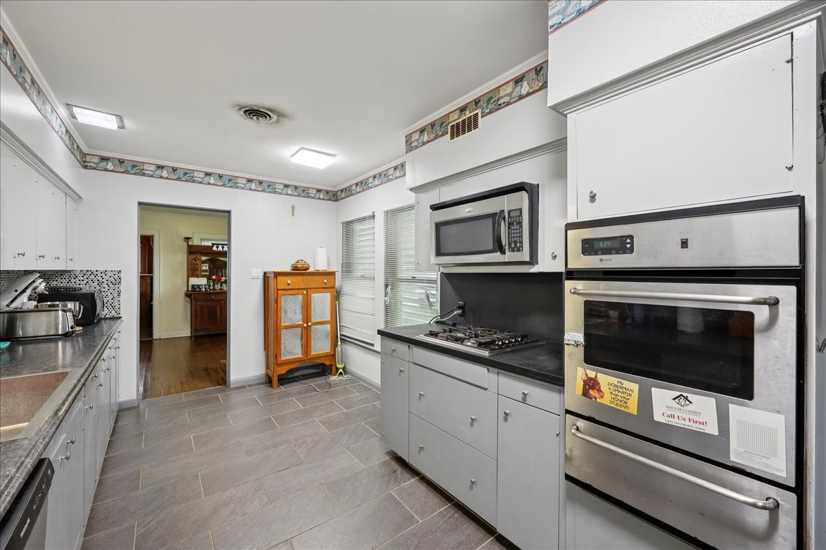 11910 Cedar Gully Road Beach City, TX 77523 - Photo 32 of 50 a kitchen with stainless steel appliances granite countertop a stove and a refrigerator