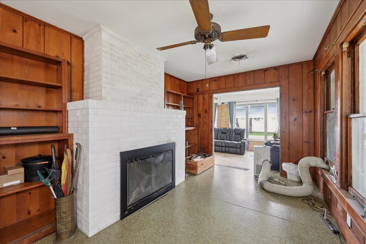 11910 Cedar Gully Road Beach City, TX 77523 - Photo 35 of 50 a living room with furniture a ceiling fan and a fireplace