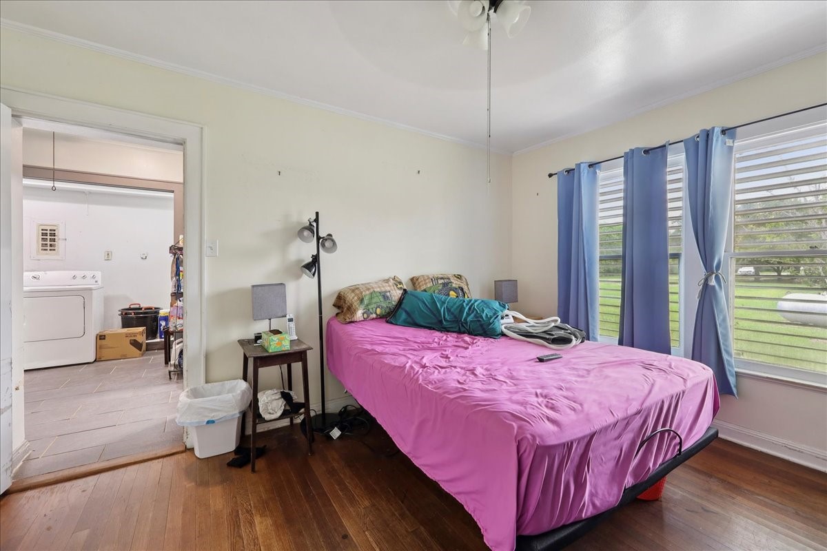 11910 Cedar Gully Road Beach City, TX 77523 - Photo 37 of 50 a bedroom with a bed and wooden floor