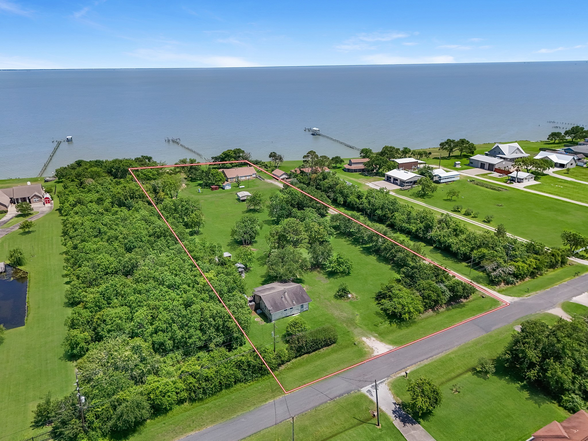 11910 Cedar Gully Road Beach City, TX 77523 - Photo 7 of 50 a backyard of a house with a yard and plants
