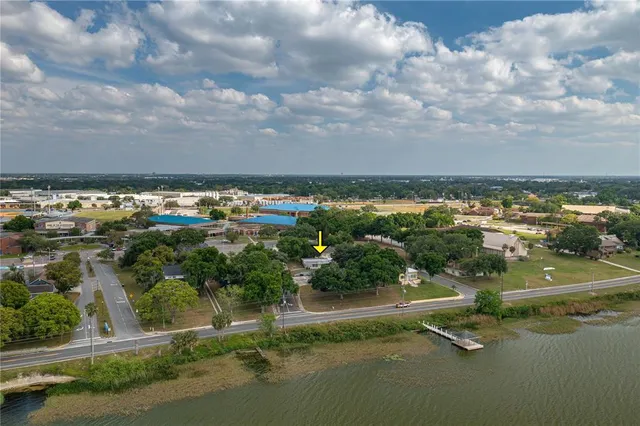 a view of a lake with houses in back