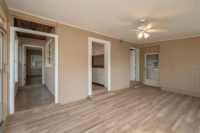 a view of empty room with wooden floor