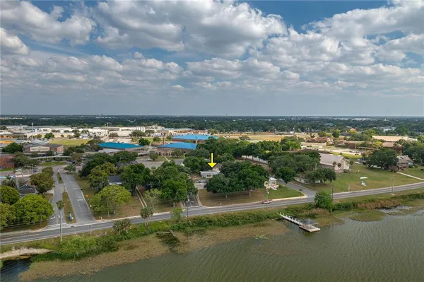 a view of a lake with houses in back