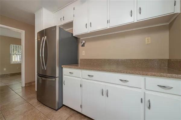 a kitchen with cabinets and stainless steel appliances