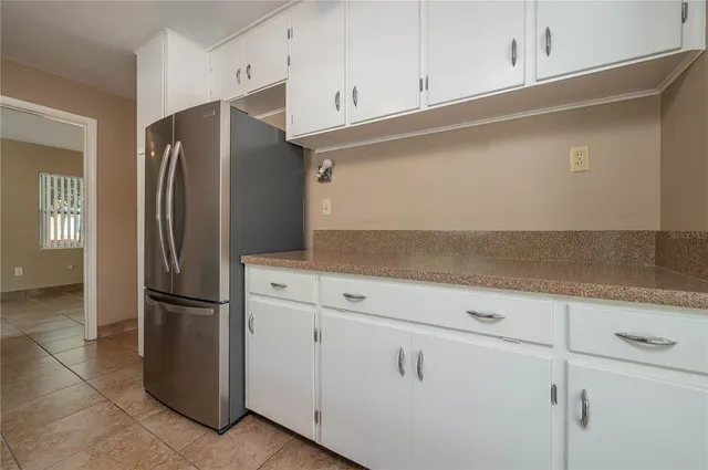 a kitchen with cabinets and stainless steel appliances