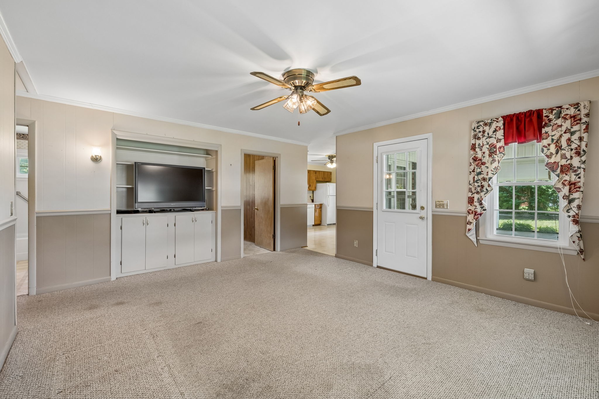 708 Hickory Street Centerville, TN 37033 - Photo 12 of 57 a view of a livingroom with a flat screen tv ceiling fan and window