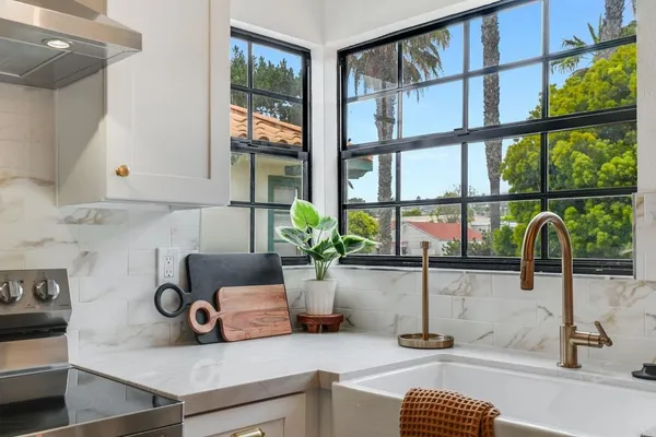 a kitchen with a sink and a large window