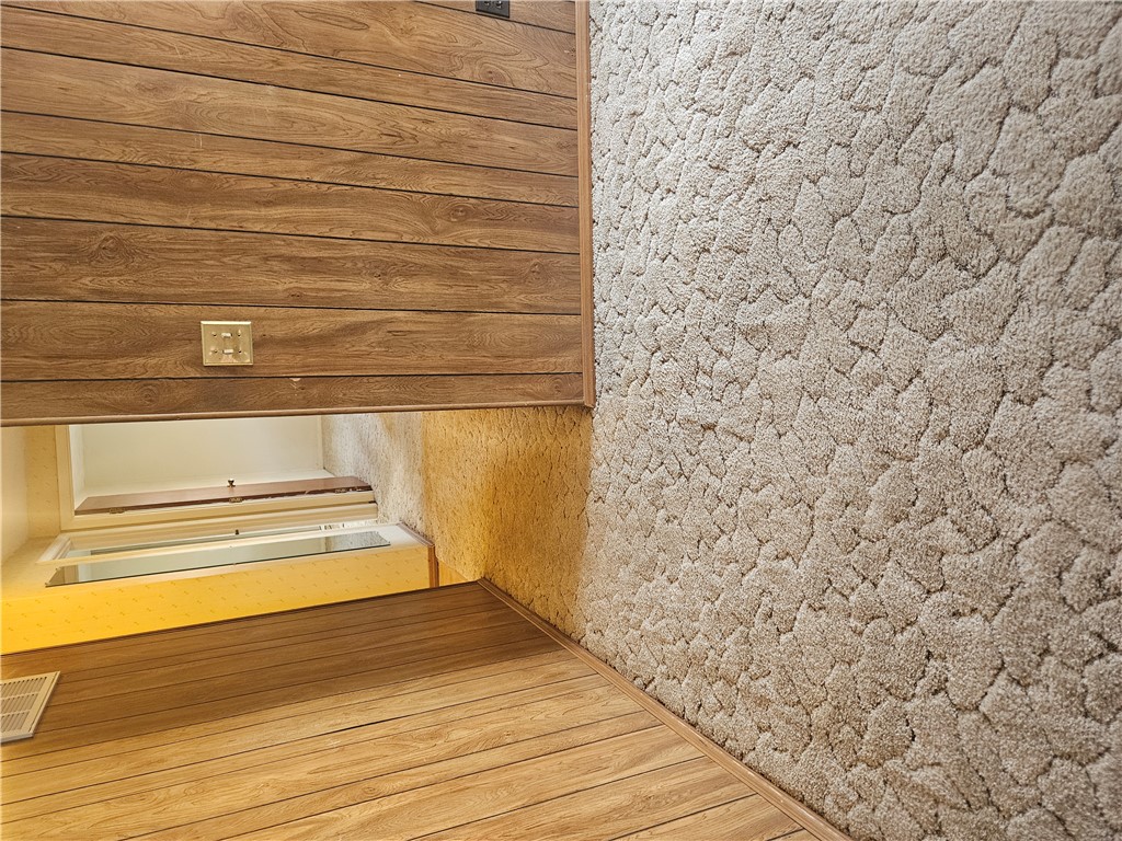 6510 Longford Road Dayton, OH 45424 - Photo 12 of 27 This interior space showcases diverse textures with wood-paneled walls and plush carpeting.