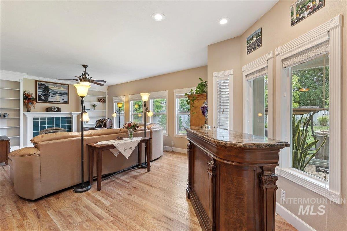 5184 North Greyloch Way Boise, ID 83704 - Photo 6 of 32 Open living area featuring wood-finish flooring, recessed lighting, and a built-in wet bar with a stone countertop