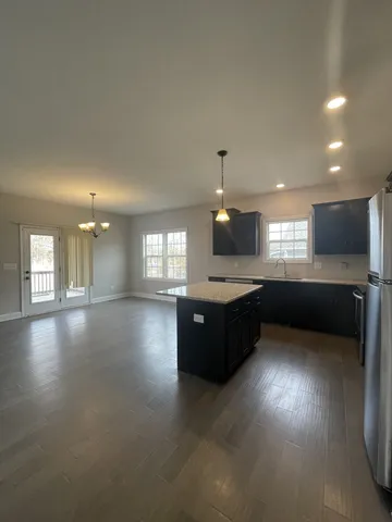 a large kitchen with a large counter top and stainless steel appliances
