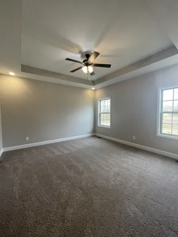 a view of a room with a ceiling fan and a window