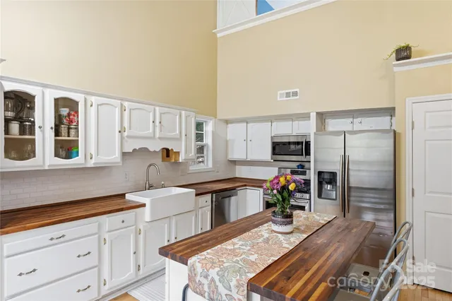 a kitchen with stainless steel appliances granite countertop a refrigerator and stove