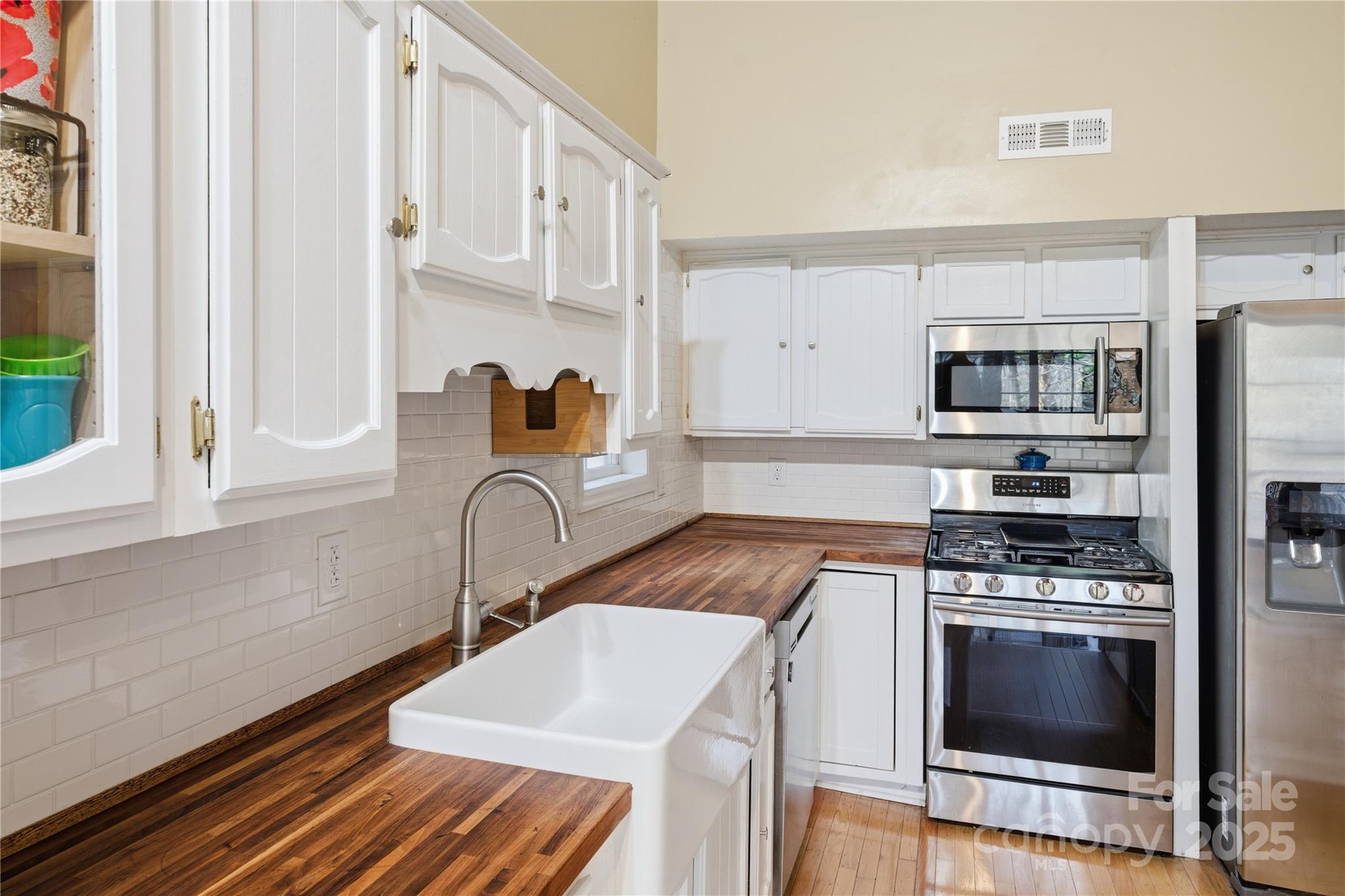 27071 Catamaran Drive Tega Cay, SC 29708 - Photo 12 of 30 a kitchen with stainless steel appliances a stove a sink and a microwave