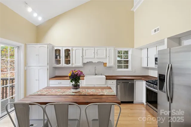 a kitchen with stainless steel appliances granite countertop a sink and refrigerator