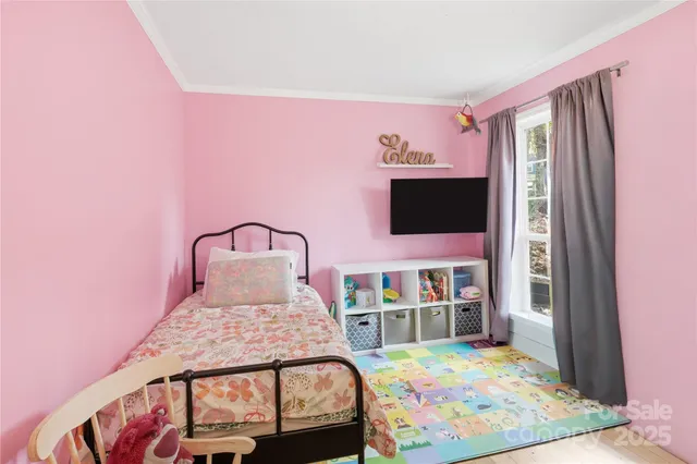 a bedroom with a bed and flat screen tv