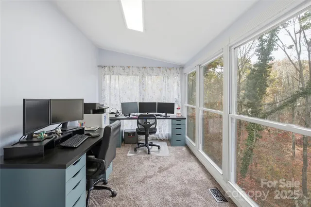 a workspace with furniture and a large window