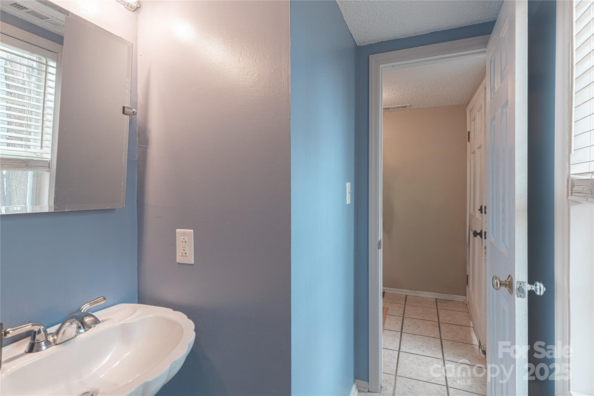 27071 Catamaran Drive Tega Cay, SC 29708 - Photo 19 of 30 a bathroom with a sink and mirror