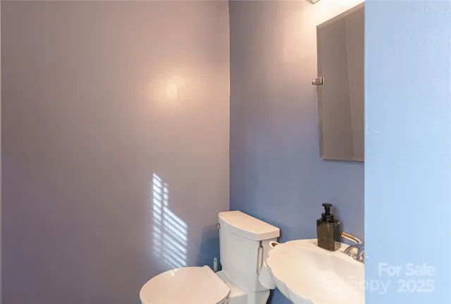 a white toilet sitting next to a bathroom sink