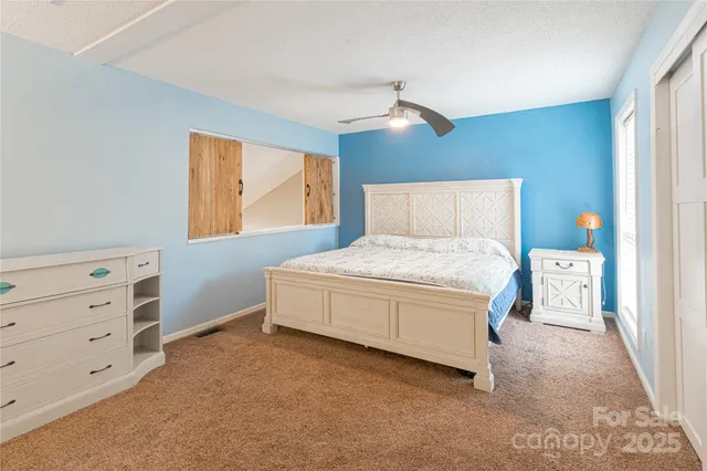 a spacious bedroom with a bed and window