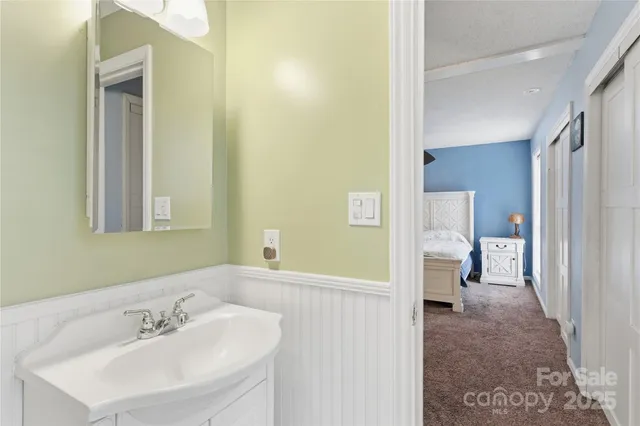 a en suite bathroom with a sink and a mirror
