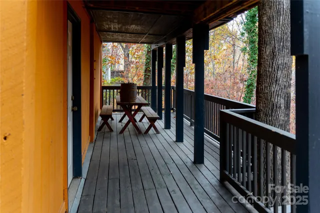 a view of a balcony with chairs and wooden floor